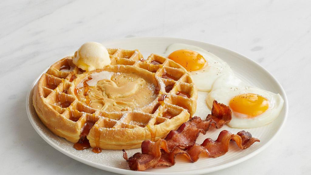 Waffle Eggs And Bacon · A Belgian waffle dusted with powdered sugar, alongside two eggs any style and two strips of applewood-smoked bacon. Served with butter and syrup.