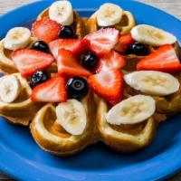 Farmer'S Fruit Basket Waffle · Our Belgian waffle dusted with powdered sugar and topped with fresh strawberries, sliced ban...