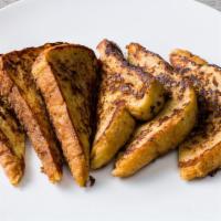 French Toast · Four thick, hand-dipped French bread slices grilled until golden and dusted with powdered su...