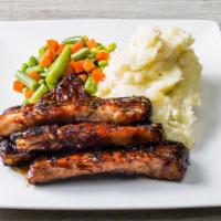 Barbecue Ribs · One pound of tender, fire-braised pork ribs, slathered in sweet and tangy barbecue sauce.