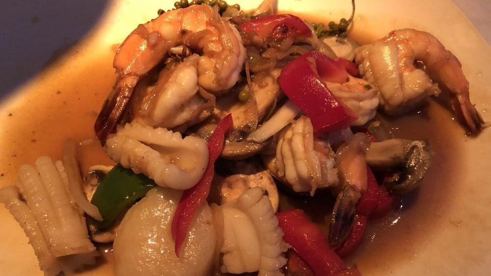 Seafood Krapow Special · Shrimp, squid, scallop and mussel sautéed with fresh basil, chili peppers, onion, garlic and bell peppers. Served with small Thai salad.