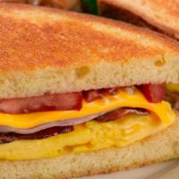 Brioche Breakfast Sandwich · Scramble Egg, Smoked Bacon, Ham, Grilled Tomatoes, Melted Cheddar Cheese & Mayonnaise On Gri...