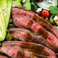 Bistro Skirt Steak Salad · Tender pieces of thinly sliced Skirt Steak over mixed mesclun greens, avocado, cherry tomato...