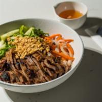 Bun Thit Nuong · Saigon-style grilled pork served on a bed of rice vermicelli noodles with lettuce, cucumber,...