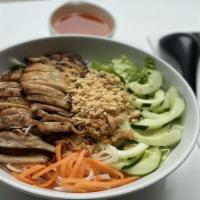 Bun Ga Nuong · Grilled chicken served on a bed of rice vermicelli noodles with lettuce, cucumber, pickled c...