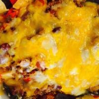 Nachos Grande · Crisp tortilla chips topped with melted jack and cheddar cheese and house-made chili, with g...
