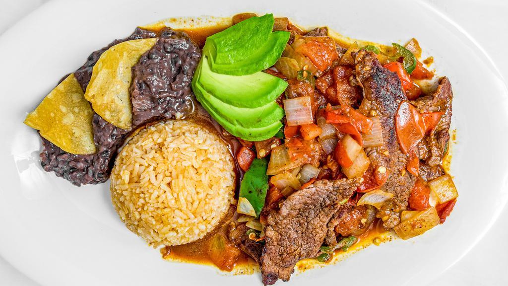 Bistec Encebollado · Sautéed beef with onions, side of rice, beans and tortillas.