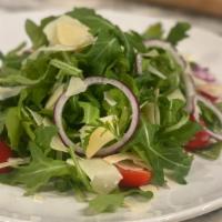 Arugula · Baby arugula, cherry tomatoes, red onion, and shaved parmigiana served in a whipped lemon, h...