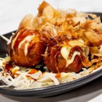 Takoyaki · Ball-shaped Japanese snack made with wheat flour based batter and filled with minced octopus...