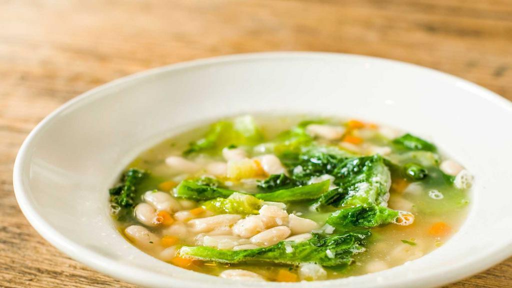 Cannellini Bean & Escarole Soup · Sauteed escarole and garlic simmered with white cannellini beans, carrots, onions, celery, and garlic in vegetable broth then topped with pecorino romano cheese.