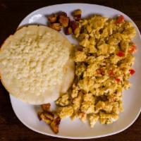 Huevos Al Gusto · Eggs any style with cheese topped arepa or rice.