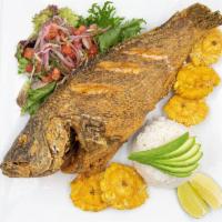 Pescado Frito / Fried Whole Fish · Marinated whole sea bass fish deep fried served with rice, creole sauce and fried green plan...