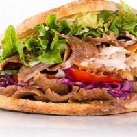 Lamb Gyro Sandwich · Savory lamb gyro with diced tomatoes, chopped onions and shredded lettuce stuffed in a homem...