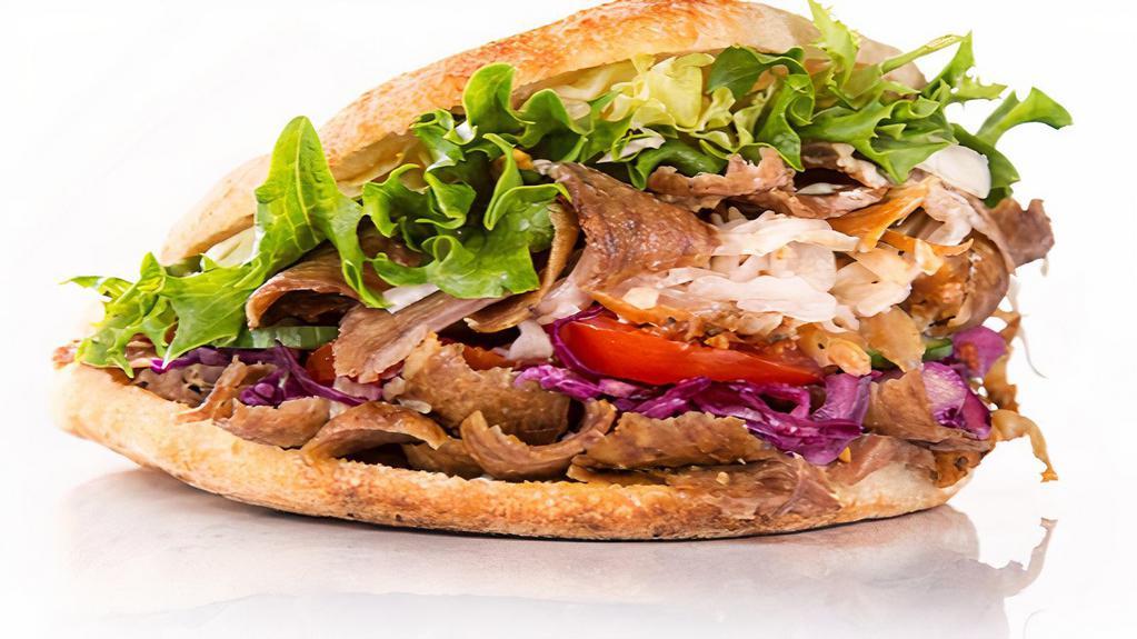 Lamb Gyro Sandwich · Savory lamb gyro with diced tomatoes, chopped onions and shredded lettuce stuffed in a homemade pita.