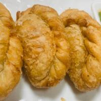 Fried Vegetable Curry Puff · Served with cucumber sauce.