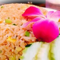Crabmeat Fried Rice · Stir fried jasmine rice with egg, crab meat, onions, scallions, chopped carrots, and tomatoes.