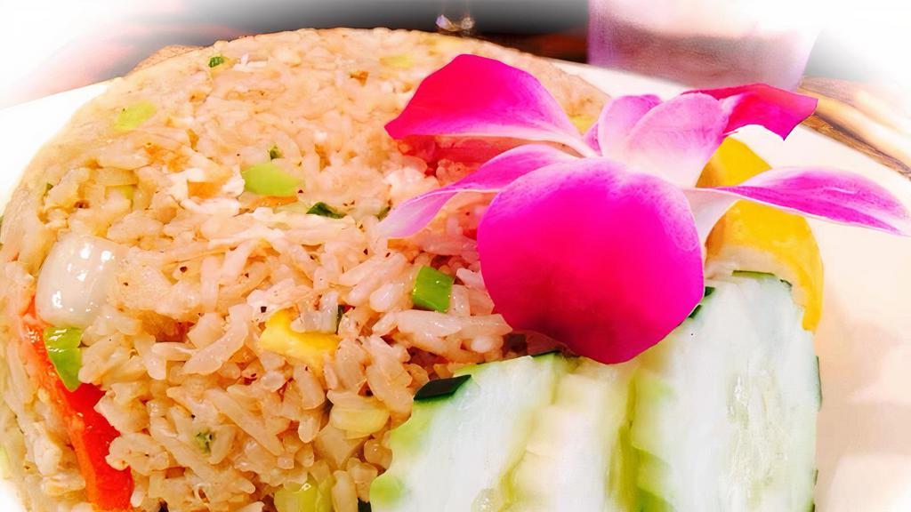 Crabmeat Fried Rice · Stir fried jasmine rice with egg, crab meat, onions, scallions, chopped carrots, and tomatoes.