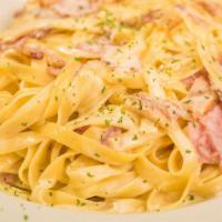 Fettuccine Carbonara · Served with ham, bacon, and mushrooms, in an Alfredo sauce. Served with a cup of soup or sal...