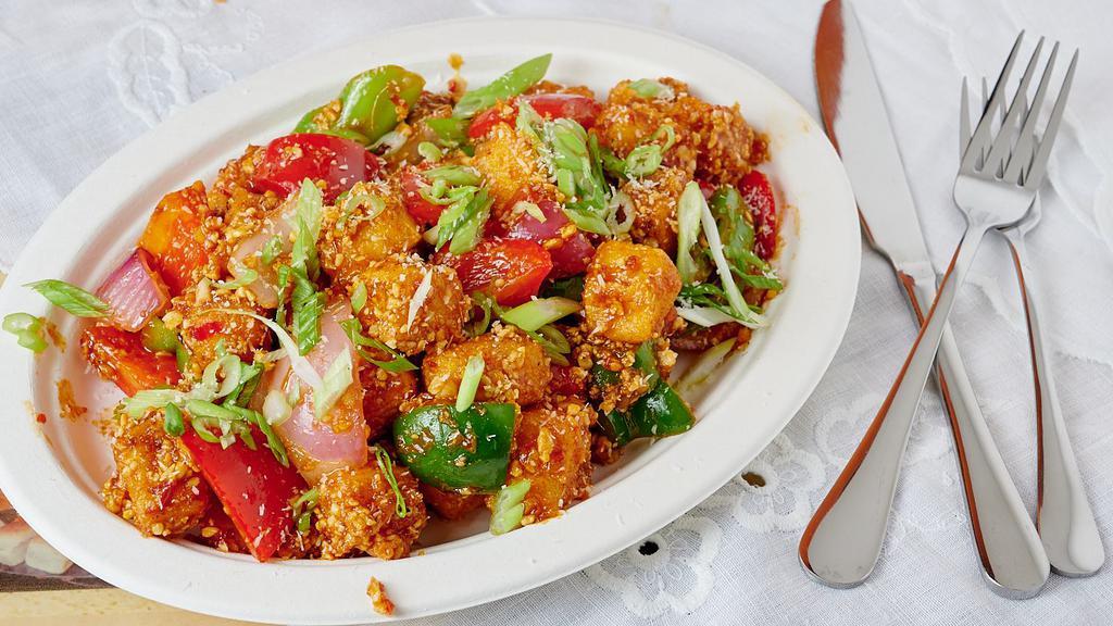 Fried Tofu · Shallow fried tofu is sautéed in chef’s special sauce with bell peppers, onions, long chilies and crushed peanuts.