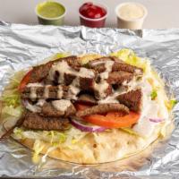 Lamb Gyro · Grilled chicken wrapped in pita bread, with lettuce, tomato, onion, and topped with white sa...
