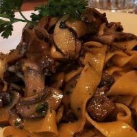 Tagliatelle Ai Porcini · Homemade with Porcini, Cremini and Shitake Mushrooms all mixed & Truffle Oil