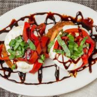 Eggplant Tower · Fried eggplant, tomato, fresh mozzarella and roasted peppers with balsamic drizzle.