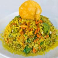 Bombay Bhel Poori · A mixture of puffed rice, sev, crispy poori, chopped potatoes and onions with fresh coriande...