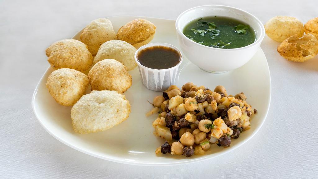 Pani Poori · Crisp bread with boiled potatoes and beans served with spicy water and tamarind sauce.