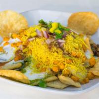 Delhi Chaat  · Aloo papdi chaat. Flour crisps with potatoes, chickpeas and onions topped with yogurt and sw...