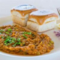 Bombay Style Pav Bhaji · Spicy mixed vegetables served with bread, lemon and onions.