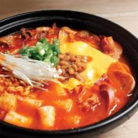 Budae Hot Pot · Spicy homemade beef broth with 3 Kinds of ham, rice cake, noodles, beans, vegetables & chees...