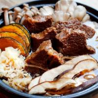 Galbi Hot Pot · Steamed galbi, burdock, napa cabbage, lotus root & assorted mushrooms in soy sauce beef brot...
