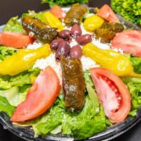 Greek Salad · Our Greek salad is made with romaine and iceberg lettuce, scallions, green and red bell pepp...