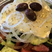 Horiatiki · (The true Greek salad) Tomatoes, cucumbers, raw onions and pepperoncini topped with feta che...