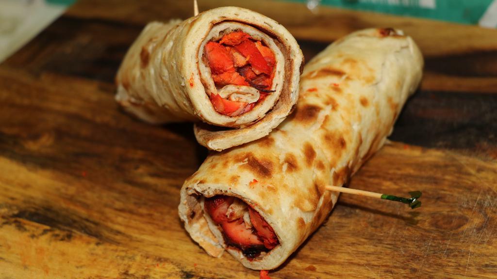 Chicken Tikka Wrap · Chicken tikka cut into pieces and added with marinated onions into a tandoori naan