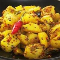 Achari Aloo · Thick sliced potatoes cooked witjh herbs, spices in a traditional pickle sauce