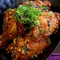 Chicken Wings · Crispy fried chicken wings tossed in our signature sweet and sticky sauce topped with sesame...
