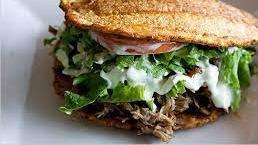 Shredded Beef Patacon · Crispy green plantain, meat, fried cheese, lettuce, tomato, and special sauces (Mayo-ketchup...