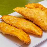 Empanada · fried pastry filled with ham, cheese, beef or chiken
