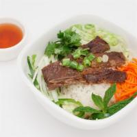 Grilled Pork Chop Rice · Grilled pork chop rice bowl comes with tomato, lettuce, pickle carrot & radish, cucumber, ci...