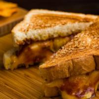 Bbq  Chicken Grilled Cheese & Dorrito Bag · Melted cheddar, mozzarella cheese with bbq breaded chicken, caramelized scallion, between tw...