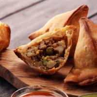 Famous Indian Chicken Samosa (3) · Hot fried pastry shells stuffed with roasted minced chicken and cumin potatoes, served with ...