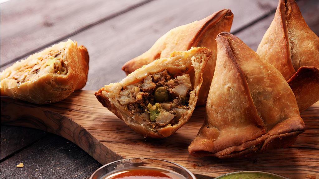 Famous Indian Chicken Samosa (3) · Hot fried pastry shells stuffed with roasted minced chicken and cumin potatoes, served with mint and tamarind chutney