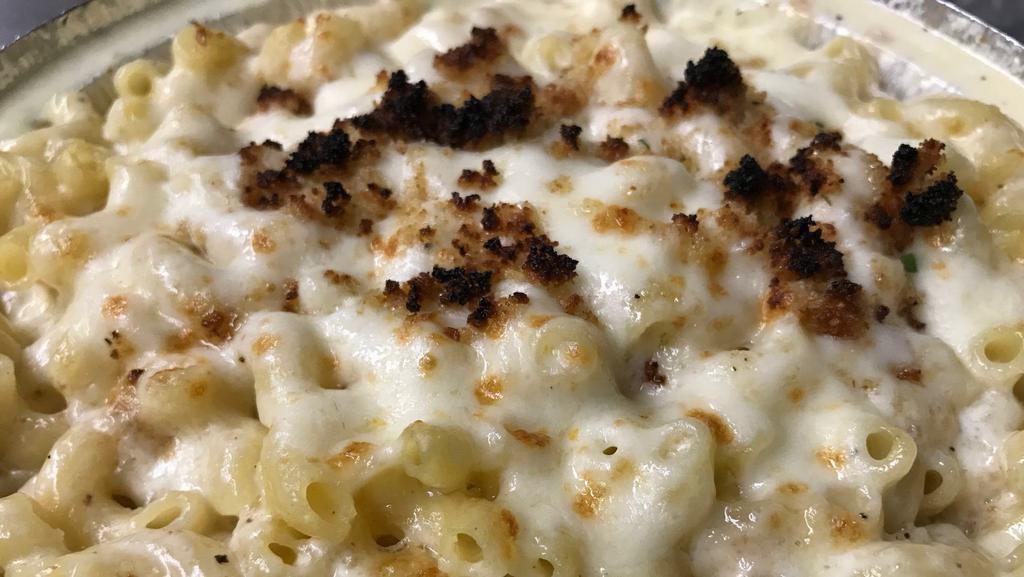 Mac-N-Cheese · White and yellow Cheddar topped with toasted bread crumbs.