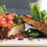 Bruschetta · Vegan. Toasted bread with rubbed garlic, topped with cherry tomatoes, arugula and black oliv...