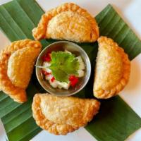 Curry Puff (4) · Pastry stuffed with ground chicken, potatoes, onion, curry powder served with cucumber sauce.
