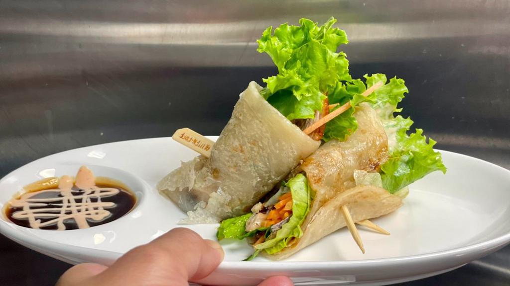 Duck Roll (Roll) · Crispy duck, cucumber, scallion, carrot wrapped in roti bread with chef's special sauce.