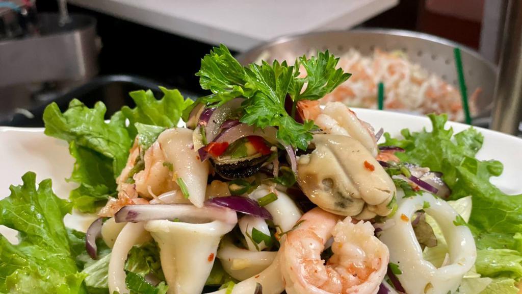 Seafood Salad · Mixed seafood (shrimps, calamari, scallops, mussels), red onions, scallion, cherry tomatoes, lime leaves, lemongrass with delicious chili lime dressing.