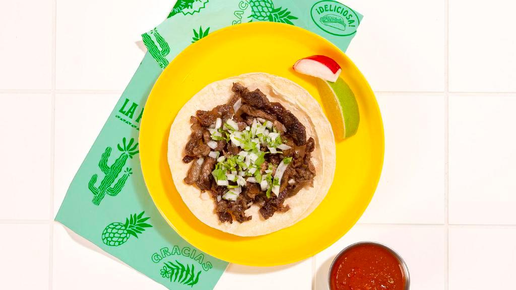 Carne Asada Taco · Marinated steak topped with cilantro and chopped onion on a soft corn tortilla.