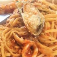 Linguini Combo · Linguini pasta served with fresh scallops, shrimp, calamari, and mussels with your choice of...